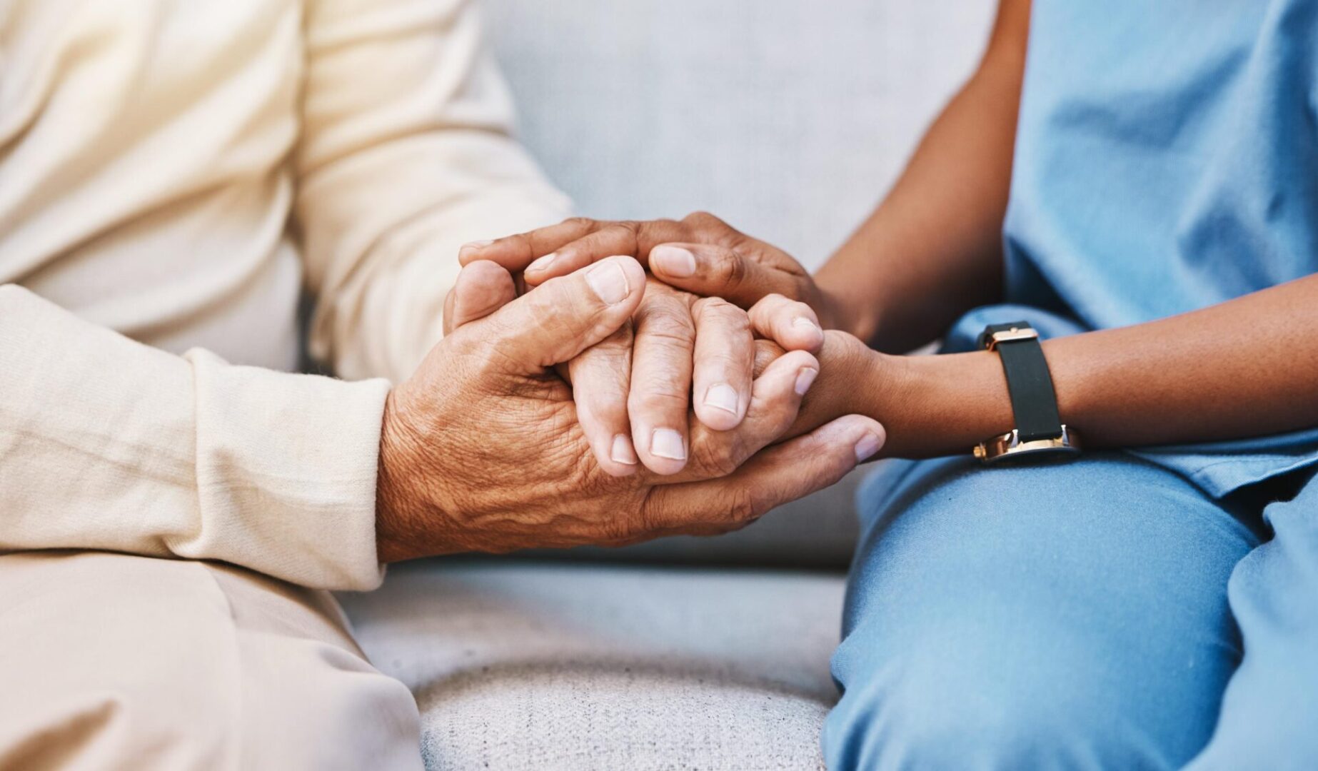 A close up of two people holding hands