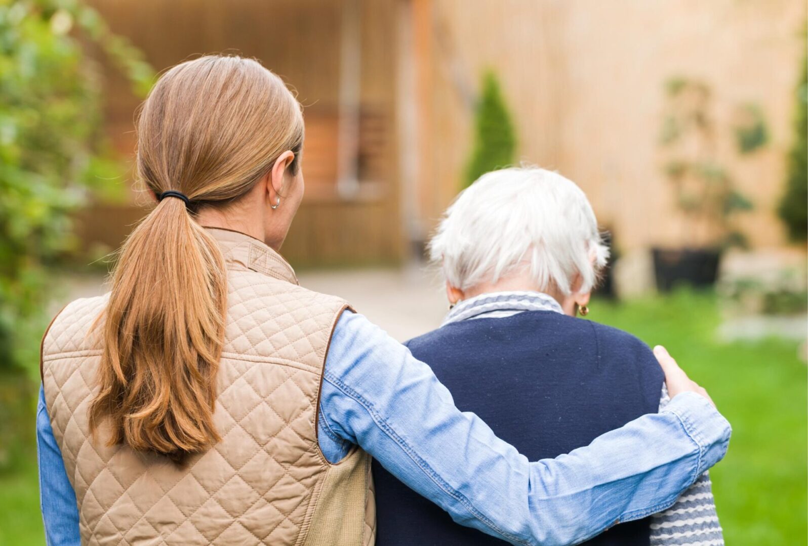 A woman and an older man are holding each other.